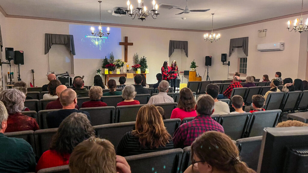 This is me (Katie McLain) and my oldest daughter sharing a reading at our Christmas Eve candlelight gathering with River Corner Church.